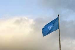 A blue United Nations flag on a pole