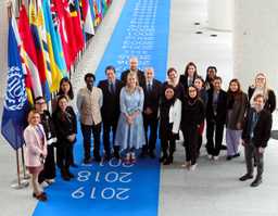A group of people posing for a photo in front of flags after the Nexus Dialogue event held in 2023 in the ILO premises.