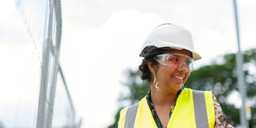 Women wearing a helmet on a building site